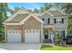 Beautiful two-story home with a three-car garage, stone accents and well-manicured landscaping at 7052 Camp Falls Ct, Winston, GA 30187