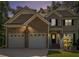 Charming two-story home featuring a stone facade and a two-car garage, set against a backdrop of mature trees at 7052 Camp Falls Ct, Winston, GA 30187