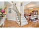 Elegant foyer with a staircase, hardwood floors, and a view of a dining room with elegant furnishings at 7052 Camp Falls Ct, Winston, GA 30187
