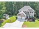 Charming two-story home with well-manicured lawn, two-car garage, and lush landscaping at 7052 Camp Falls Ct, Winston, GA 30187