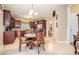 Open kitchen with wooden cabinetry, granite countertops, stainless appliances, and an adjacent breakfast nook at 7052 Camp Falls Ct, Winston, GA 30187