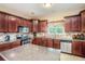 A well-appointed kitchen featuring granite countertops, stainless steel appliances, and dark wood cabinetry at 7052 Camp Falls Ct, Winston, GA 30187