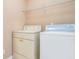Bright laundry room with washer, dryer, and wire shelf for organized storage at 7052 Camp Falls Ct, Winston, GA 30187