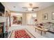 Spacious living room featuring a fireplace, plush carpeting, ornate decor, and windows overlooking the yard at 7052 Camp Falls Ct, Winston, GA 30187