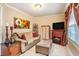 Comfortable living room with fireplace and large floral artwork at 7052 Camp Falls Ct, Winston, GA 30187