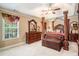 Spacious primary bedroom with a decorative canopy bed and ample natural light at 7052 Camp Falls Ct, Winston, GA 30187