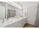 Modern bathroom with double sinks, marble countertops, contemporary lighting, and ample storage space at 1039 Avery Creek Dr, Woodstock, GA 30188