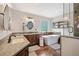 Inviting bathroom with a freestanding tub, stylish fixtures, and marble flooring at 1039 Avery Creek Dr, Woodstock, GA 30188