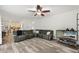 Spacious living room with wood-look floors, a comfortable sectional sofa, and modern ceiling fan at 1039 Avery Creek Dr, Woodstock, GA 30188