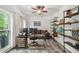 Comfortable home office featuring wood-look flooring, built-in shelves, and a backyard view at 1039 Avery Creek Dr, Woodstock, GA 30188