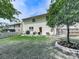 Spacious backyard with lush green grass, patio, and beautiful landscaping with rock border at 423 Livingston Pt, Acworth, GA 30102
