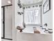 Relaxing bathroom featuring a soaking tub, decorative shelves, and natural light at 423 Livingston Pt, Acworth, GA 30102