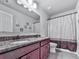 Bathroom vanity boasts granite countertop, double sinks, and tub shower combo at 423 Livingston Pt, Acworth, GA 30102