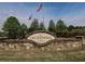 Stone monument displaying the Centennial Lakes community name with flags flying above at 423 Livingston Pt, Acworth, GA 30102