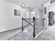 Upstairs hallway with neutral carpet, decorative railing, and access to rooms at 423 Livingston Pt, Acworth, GA 30102