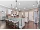 Modern kitchen featuring a breakfast bar, pendant lighting, and stainless steel appliances at 423 Livingston Pt, Acworth, GA 30102