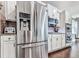 Updated kitchen with stainless steel refrigerator, white cabinets, and dark wood flooring at 423 Livingston Pt, Acworth, GA 30102