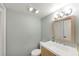 Bathroom featuring a stylish vanity with a framed mirror and modern lighting at 57 Cantey Nw Pl, Atlanta, GA 30327