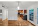 Dining area featuring hardwood floors and French doors to the patio, next to the kitchen at 57 Cantey Nw Pl, Atlanta, GA 30327