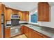 Well-appointed kitchen with updated stainless steel appliances and dark countertops for cooking at 57 Cantey Nw Pl, Atlanta, GA 30327