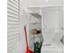 Functional laundry room equipped with a stacked washer and dryer unit and wire shelving at 57 Cantey Nw Pl, Atlanta, GA 30327