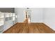 Open-concept living area with gleaming hardwood floors and custom shelving, bathed in natural light at 57 Cantey Nw Pl, Atlanta, GA 30327