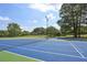Well-maintained tennis court surrounded by trees, providing recreational opportunities at 57 Cantey Nw Pl, Atlanta, GA 30327