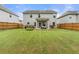 Fenced backyard with a well-kept lawn, patio, and plenty of space for outdoor activities at 2680 Lower Village Dr, Ellenwood, GA 30294