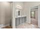 Bathroom with double sinks, tile floor, vanity, and view of the bedroom at 2680 Lower Village Dr, Ellenwood, GA 30294