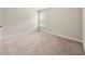 Carpeted bedroom showcasing neutral walls and natural light from a window at 2680 Lower Village Dr, Ellenwood, GA 30294