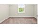 Walk-in closet with carpet and a window allowing for natural light at 2680 Lower Village Dr, Ellenwood, GA 30294