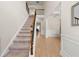 Inviting foyer with a staircase, light wood floors, and elegant wall paneling at 2680 Lower Village Dr, Ellenwood, GA 30294