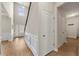 Bright and spacious foyer featuring hardwood floors, wainscoting, and tall ceilings at 2680 Lower Village Dr, Ellenwood, GA 30294