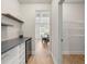 Hallway with storage room, shelves, a wine cooler, and view of the dining room at 2680 Lower Village Dr, Ellenwood, GA 30294