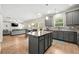 Open-concept kitchen with a center island overlooking the living area and featuring stainless appliances at 2680 Lower Village Dr, Ellenwood, GA 30294
