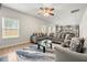 Comfortable living room with an L-shaped sofa, modern area rug, and an adjacent kitchen at 2680 Lower Village Dr, Ellenwood, GA 30294