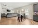 Open living room with lots of light, a ceiling fan, a large grey sofa, and a decorative fireplace at 2680 Lower Village Dr, Ellenwood, GA 30294