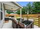 Covered patio showcasing a large dining table with outdoor seating and fenced-in backyard at 2680 Lower Village Dr, Ellenwood, GA 30294
