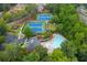 Aerial view of tennis courts, a community pool, a clubhouse, and a parking lot at 2688 Hidden Falls Ne Dr, Buford, GA 30519