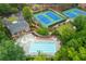 Overhead view of tennis courts, a pool, a clubhouse, a playground, and lush greenery at 2688 Hidden Falls Ne Dr, Buford, GA 30519