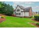 Sprawling backyard featuring a well-manicured lawn and mature trees surrounding the property at 2688 Hidden Falls Ne Dr, Buford, GA 30519