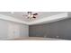 Bedroom with a neutral color scheme, ceiling fan, and access to a walk-in closet at 2688 Hidden Falls Ne Dr, Buford, GA 30519