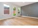 Bedroom with laminate floors, neutral paint colors, and three windows with backyard views at 2688 Hidden Falls Ne Dr, Buford, GA 30519