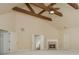Large bonus room with high vaulted ceilings, exposed wood beams, fireplace, and entryways to other rooms at 2688 Hidden Falls Ne Dr, Buford, GA 30519