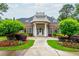 A clubhouse with a portico entrance is surrounded by manicured lawns and gardens at 2688 Hidden Falls Ne Dr, Buford, GA 30519