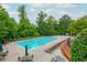 Resort-style pool area with lounge chairs, umbrellas, and landscaped surroundings at 2688 Hidden Falls Ne Dr, Buford, GA 30519