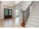 Elegant foyer with hardwood floors, staircase, and double doors leading to the front of the home at 2688 Hidden Falls Ne Dr, Buford, GA 30519