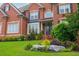 Beautiful brick home with manicured lawn, mature shrubbery, and a covered front porch at 2688 Hidden Falls Ne Dr, Buford, GA 30519