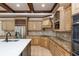 Close-up of the kitchen with wood cabinets, tiled backsplash and stainless-steel refrigerator at 2688 Hidden Falls Ne Dr, Buford, GA 30519