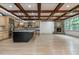 Open kitchen design with a dark island, light wood cabinets, and stone fireplace nearby at 2688 Hidden Falls Ne Dr, Buford, GA 30519
